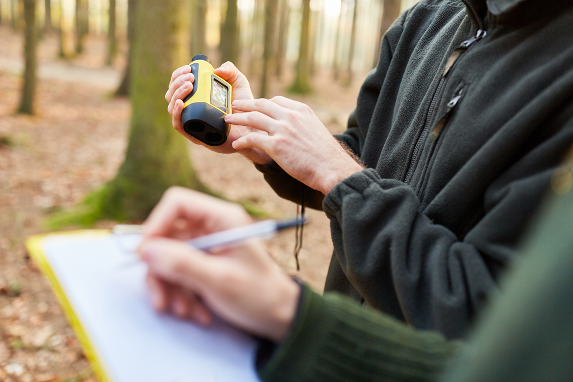 Foresters with Rangefinder in Forest Care